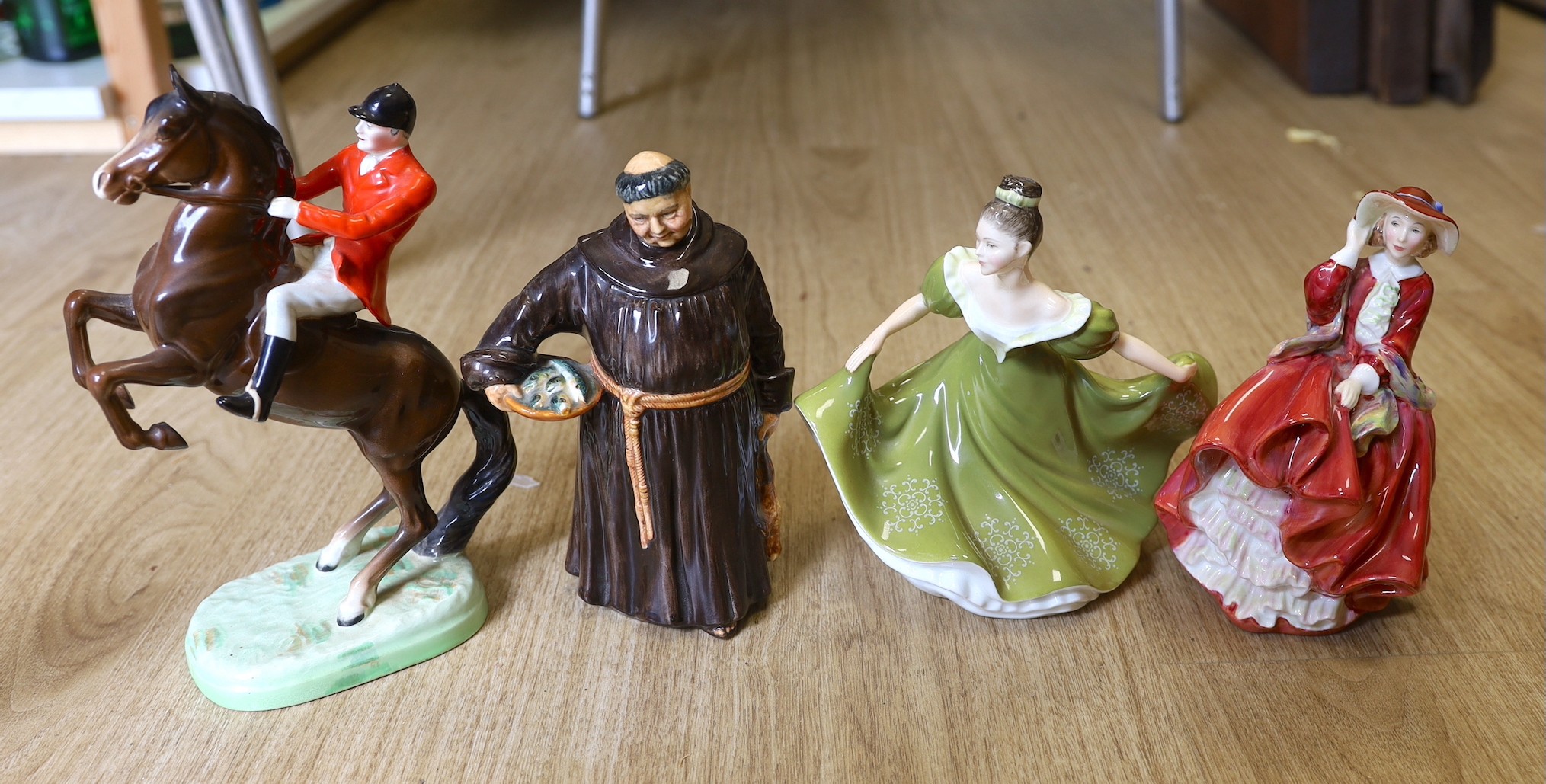 A Beswick figure group of a rearing horse and rider, a Doulton figure, The jovial monk, Top o’ the Hill and Lynne.